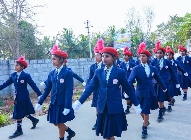 Students marching in NCC parade formation at Auxilium School Maradiyur